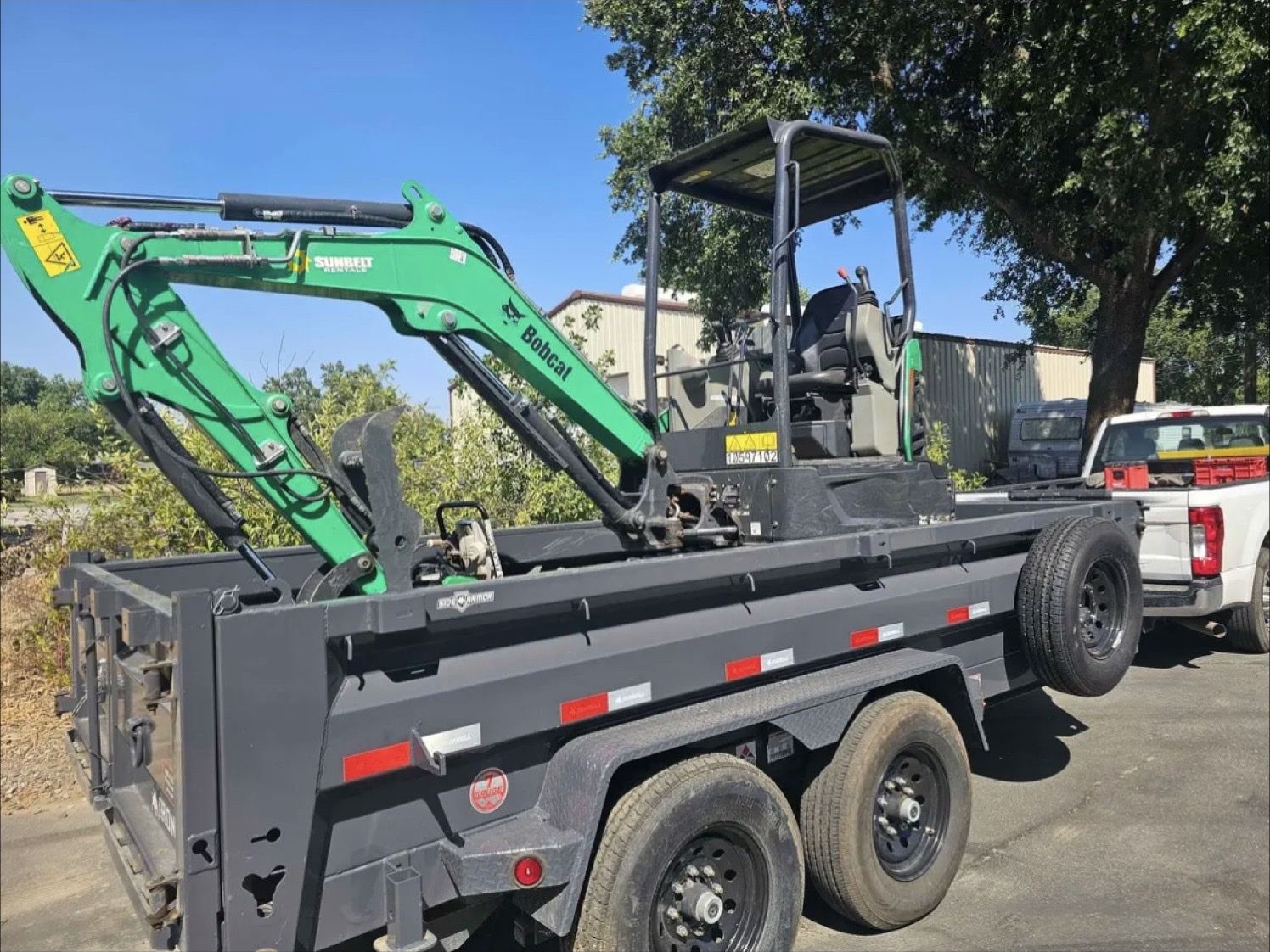 Dump trailer loaded with a mini excavator